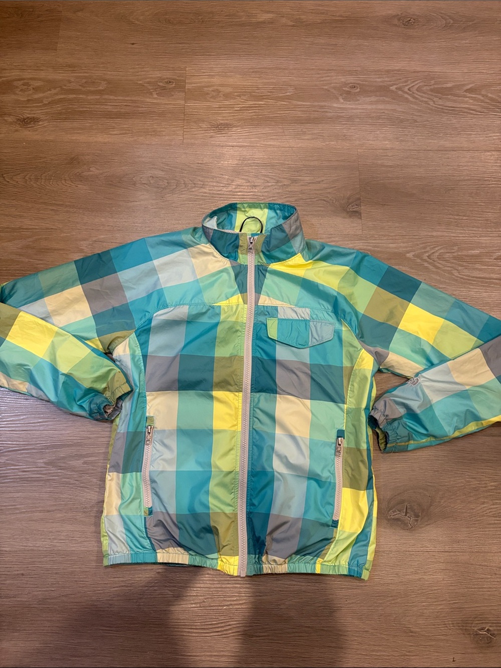 The North Face women’s  Gingham LightweightRain Jacket in Teal, Yellow & Gray